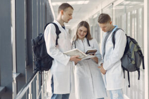Medical students at the hall. People in a white uniform
